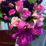 a bouquet of flowers with a pink bow