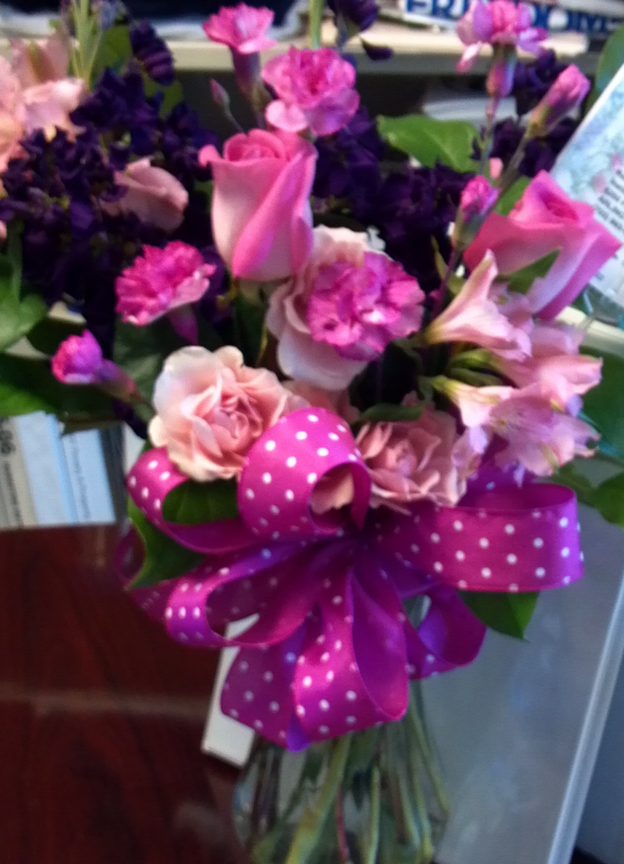 a bouquet of flowers with a pink bow