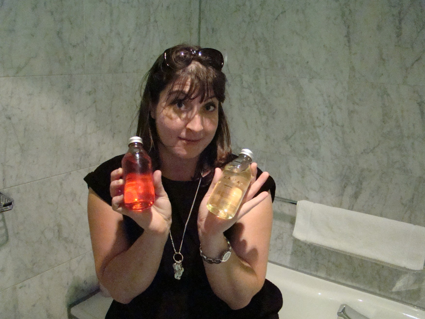 a woman holding two bottles