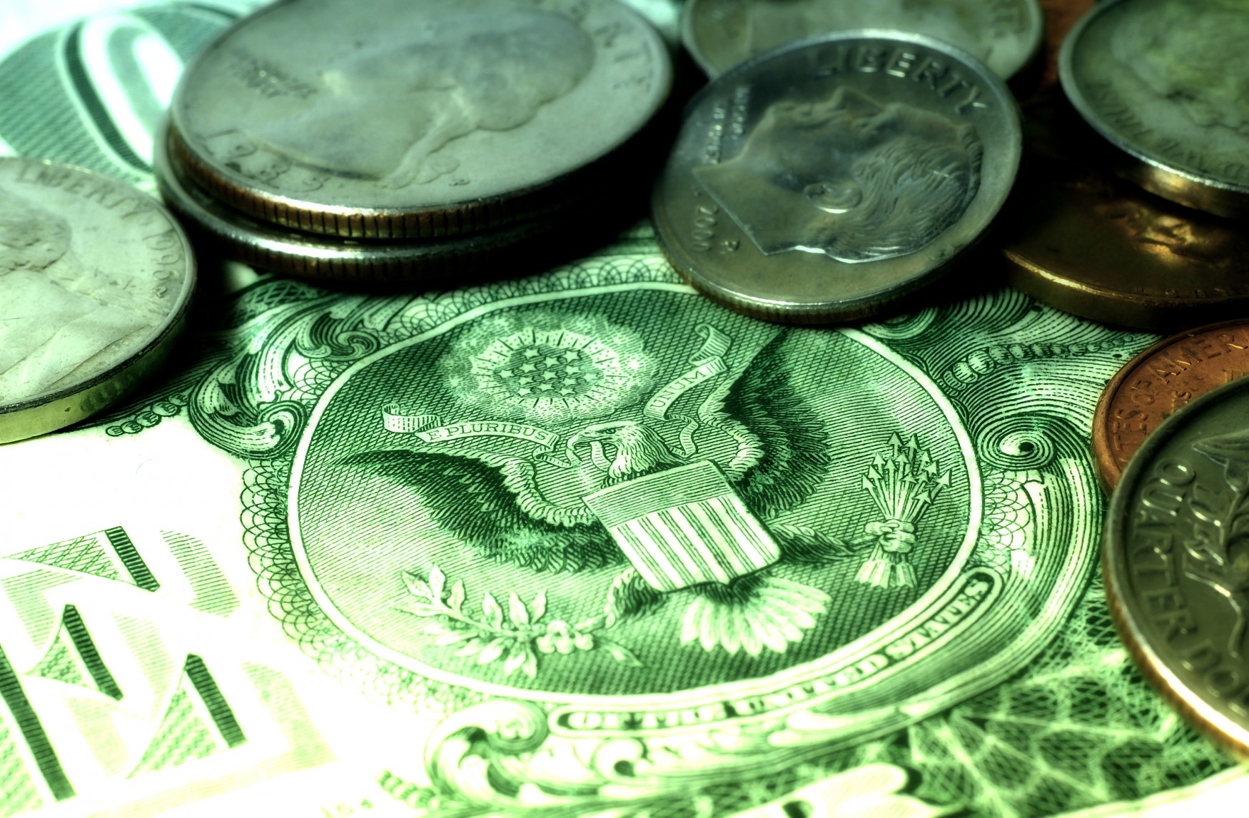 a close up of coins on a dollar bill