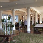 a lobby with columns and flowers