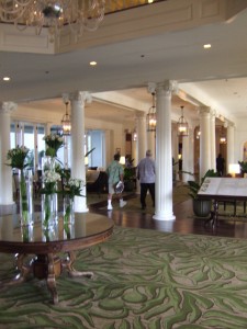 a lobby with columns and flowers