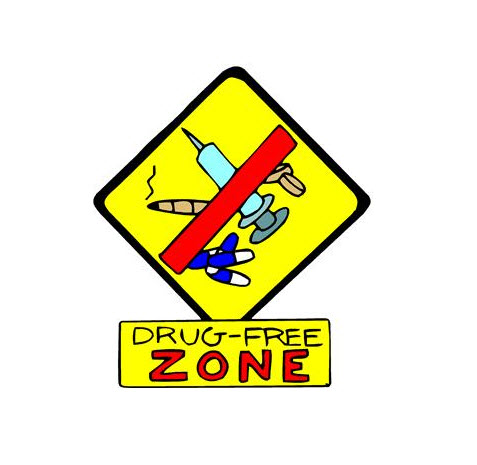 a yellow sign with a sign and a sign with a drug free zone
