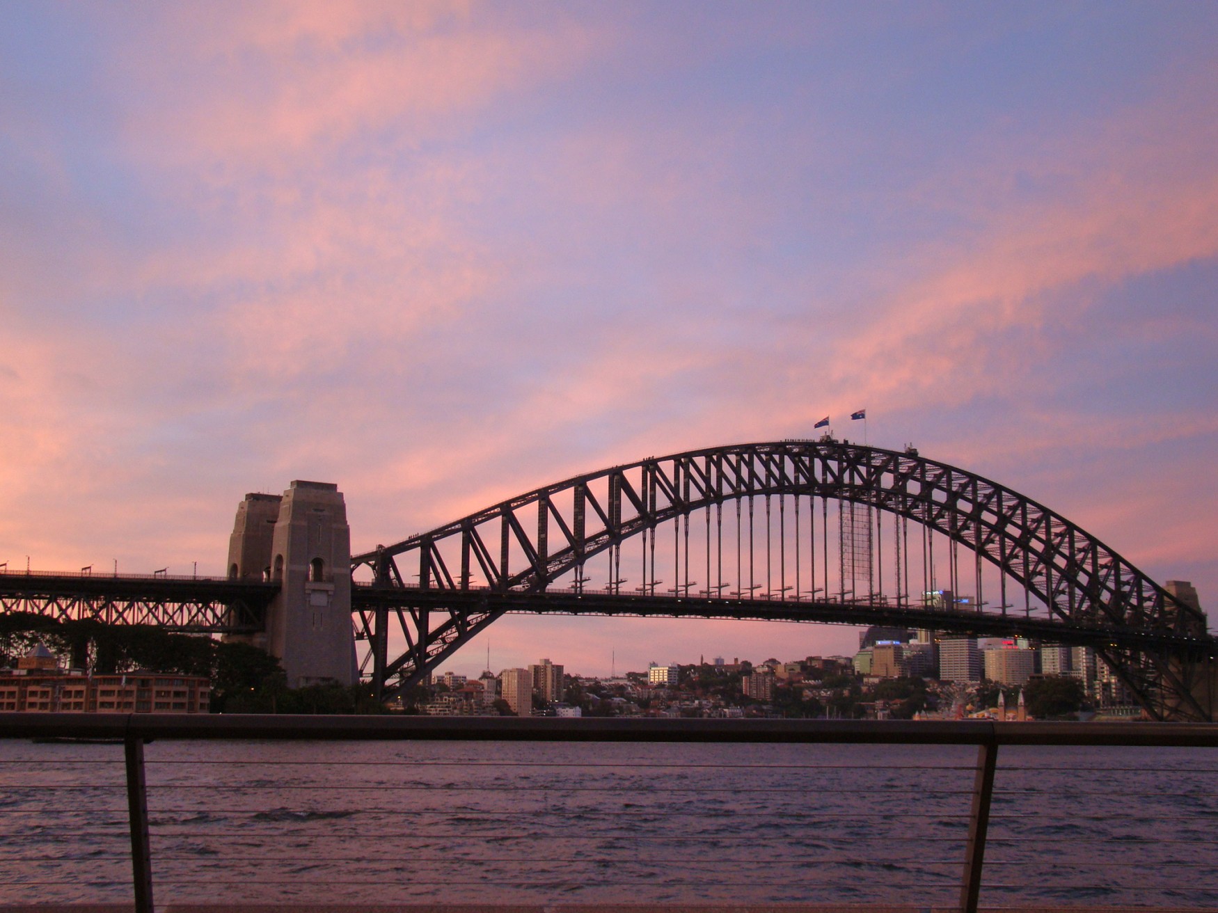Sydney Harbour Bridge over water with buildings in the background