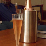a champagne glass and a bottle on a table