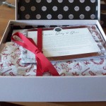 a box with a card and a red ribbon