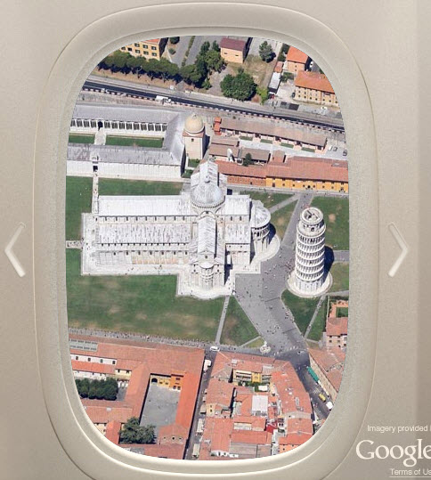 an airplane window with a building and buildings