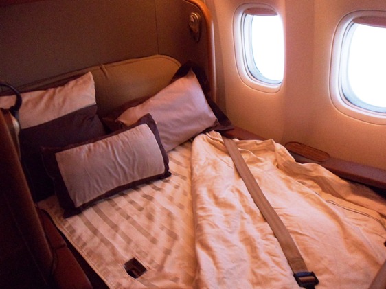 a bed with pillows and a seat belt on it