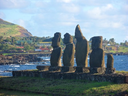 a group of stone statues on a beach