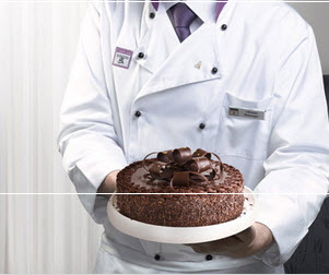 a man holding a chocolate cake