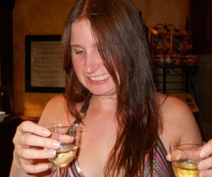 a woman holding wine glasses