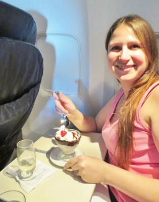 a woman eating dessert in an airplane