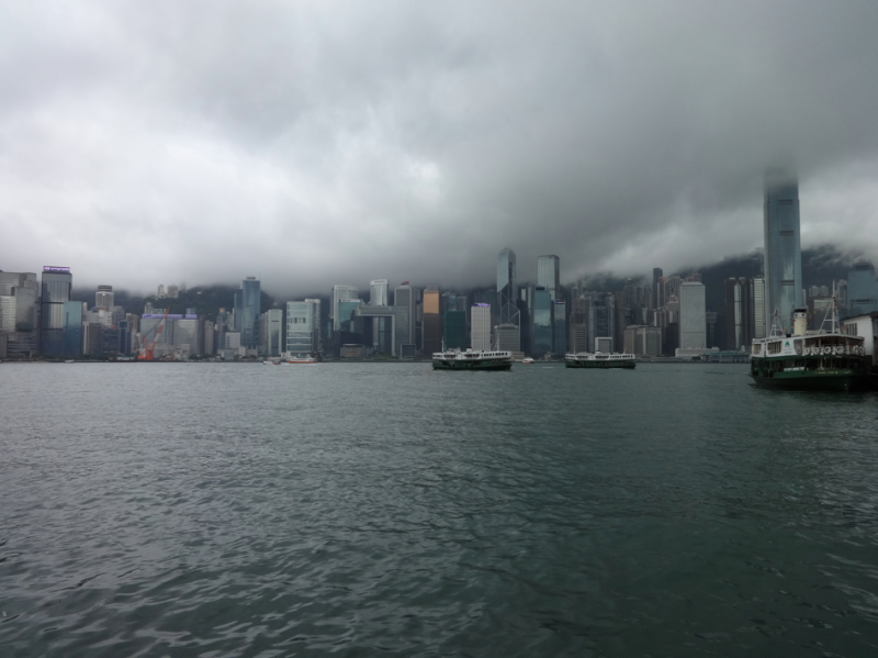 a city skyline with boats in the water