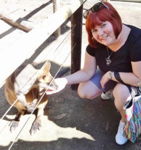a woman feeding a kangaroo