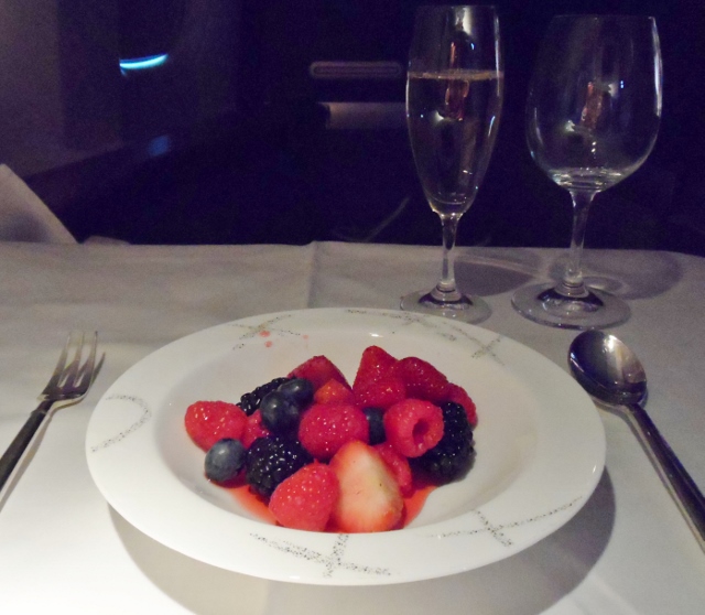 a plate of fruit and wine glasses