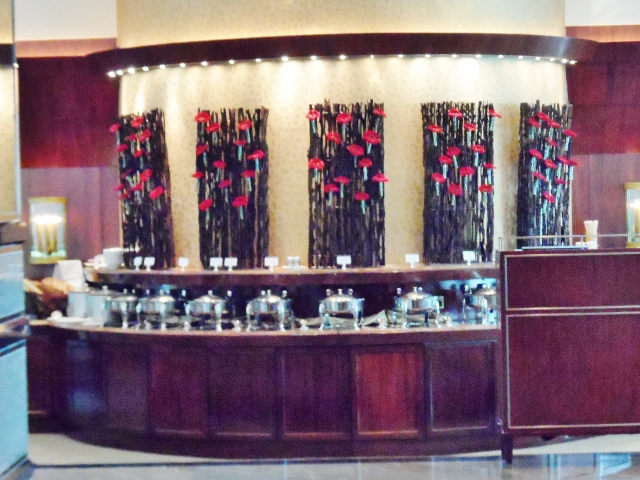 a buffet table with red flowers