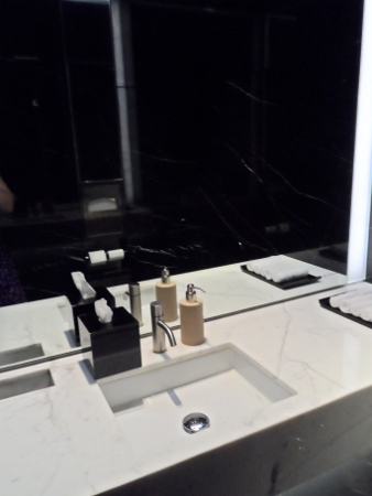 a bathroom sink with soap dispensers