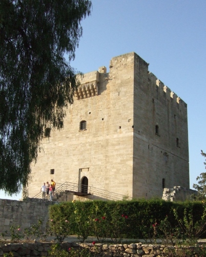 a stone building with a stone wall with Kolossi Castle in the background