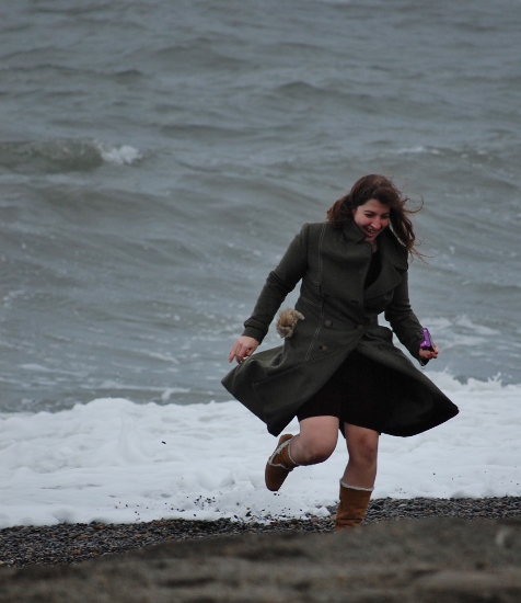 a woman running on a beach