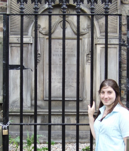 a woman standing in front of a gate
