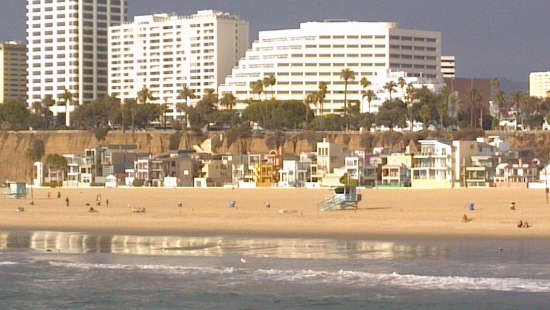 a beach with buildings and a body of water