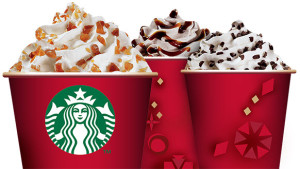 a group of red cups with whipped cream and chocolate chips
