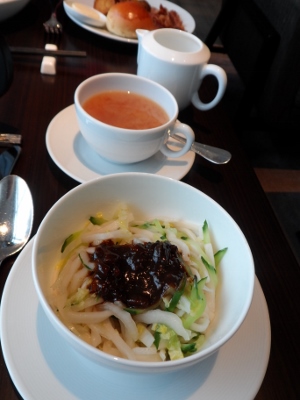 a bowl of noodles and a cup of soup
