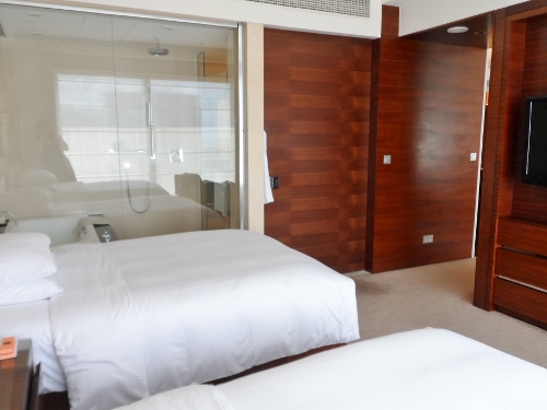 a hotel room with a glass door