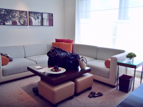 a room with a couch and a bag on a coffee table
