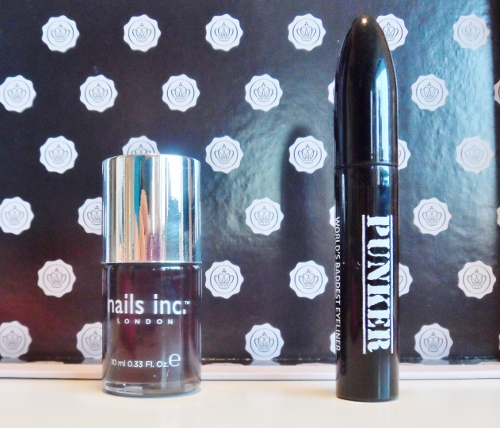 a bottle of nail polish next to a black tube