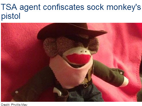a stuffed monkey with a cowboy hat and a gun