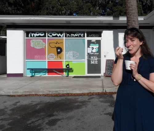 a woman eating a cup of ice cream