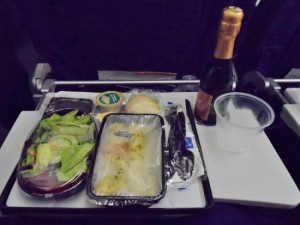 food on a tray with a bottle of champagne