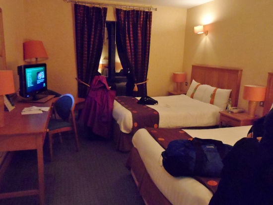 a room with two beds and a computer