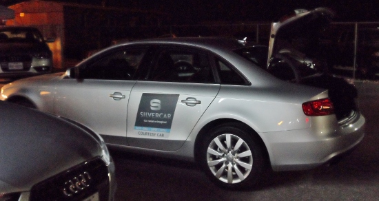 a silver car with a sign on the side