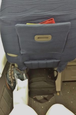 a seat with a bag and a bag on the floor