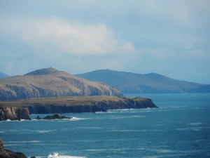 a body of water with hills in the distance