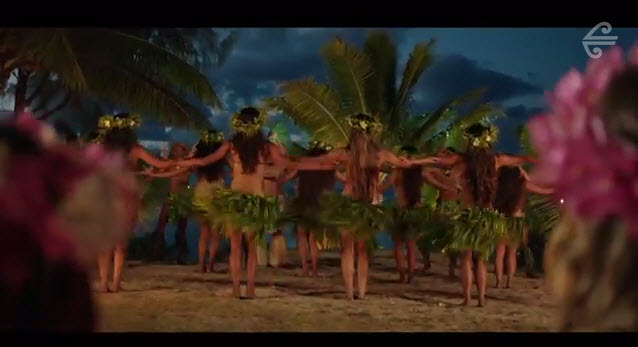 a group of women dancing on a beach
