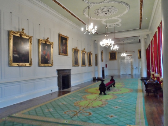 a long room with a bench and a rug