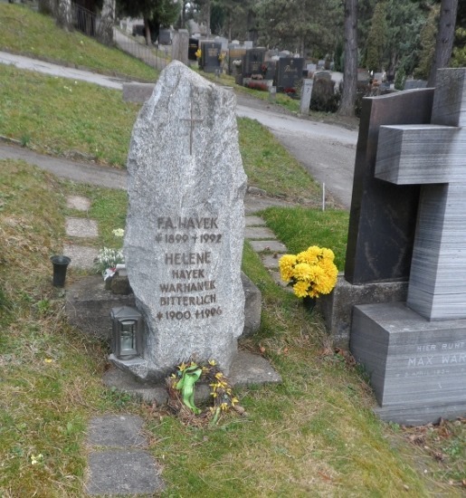 a tombstone with a cross and flowers
