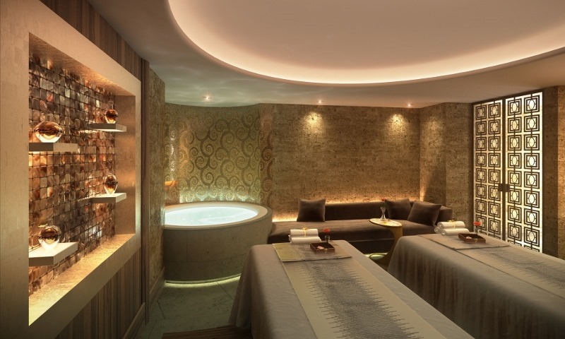 a spa room with a massage table and a tub