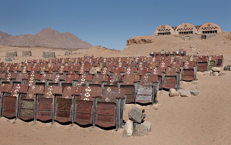 a large group of chairs in a desert