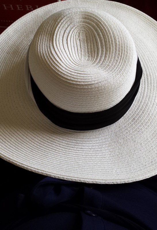 a white hat with a black band