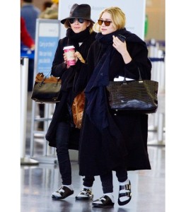 a couple of women walking in an airport