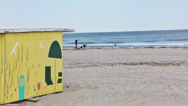 a yellow building on a beach