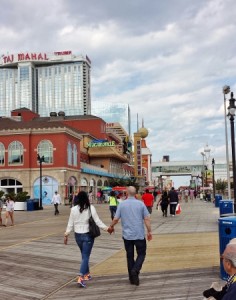 a man and woman walking on a boardwalk