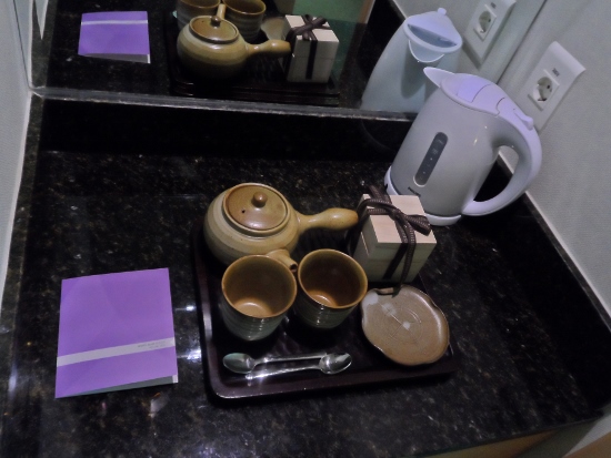 a tray with teapots and cups on it