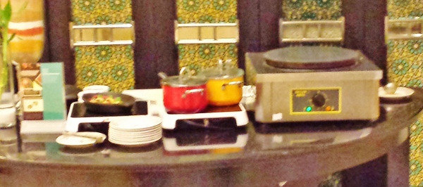 a kitchen counter with pots and plates