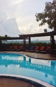 a pool with chairs and a pergola