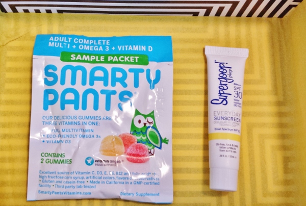 a package of vitamins and a tube of sunscreen